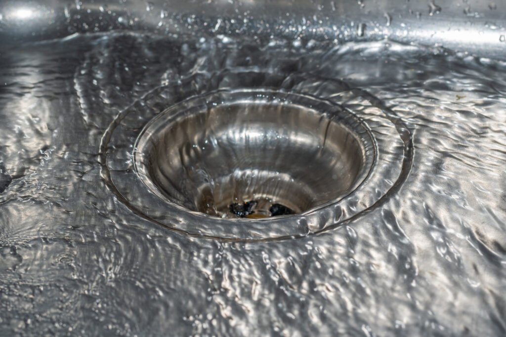 Water drain in silver sink - flowing water